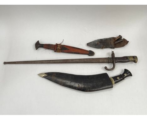 A 19th Century French Gras bayonet with scabbard, an African leather bound knife and a decorative kukri with knives (3) 
