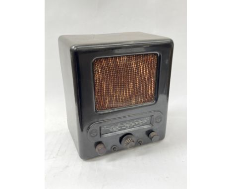 A Third Reich era German VE301 radio, Bakelite case with textile speaker cover, two Nazi Swastika roundels, a/f 