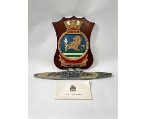 An HMS Vanguard crest together with a souvenir book and model (3) 