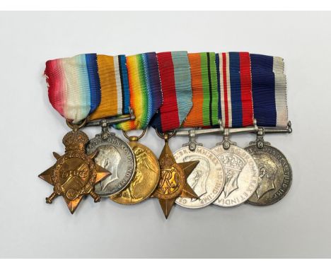A WWI and WWII medal group of seven consisting of WWI 1915 star trio, WWII 1939-45 star, War Medal and Defence Medal and Geor