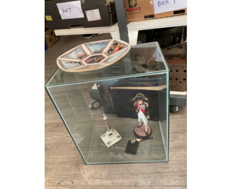 A display case with Nelson plate and model, together with a quantity of books including HMS Bulwark and Minesweeping 