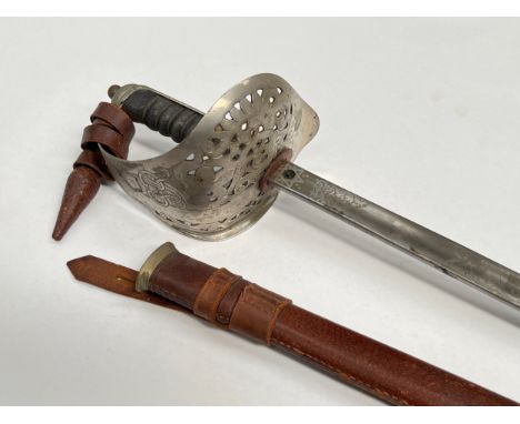A British 1897 pattern officer’s sword with George VI cypher, acid etched blade, battledress scabbard, leather portepee knot 