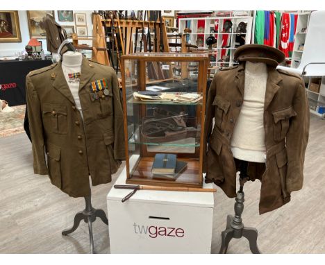 A WWI officer's jacket and peaked cap together with medals, holster, Sam Browne belt with frog and ephemera. A WWII officer's