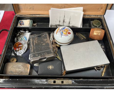 A tin of miscellaneous items including HMS Ganges teak barrel, vintage binoculars and insignia 