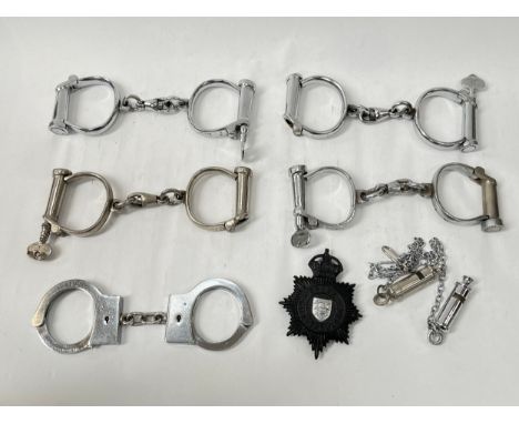 Five pairs of 20th Century handcuffs including Hiatt, together with two police whistles and King's Crown Essex Constabulary h
