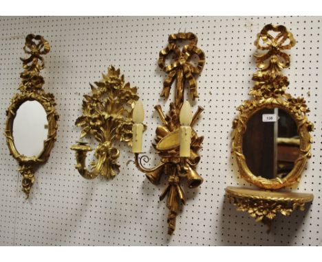 An Italian Euromarchi gilt pier glass, suspended from ribbon tied foliage, 62cm high; another;    a similar two light wall pe