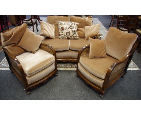 A three piece Bergere suite comprising two seat sofa and two armchairs..