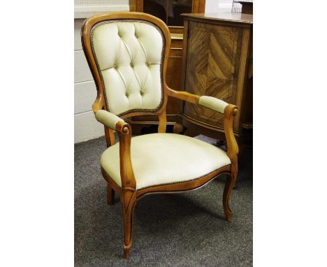 A reproduction open armchair, button upholstered back, padded seat, French cabriole forelegs