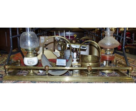 An early 20th century brass fire fender; oil lamps; desk lamp; coal scuttle; etc qty