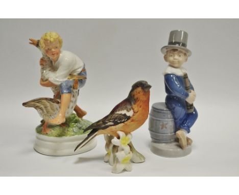 A Royal Copenhagen porcelain figure of a boy with two geese, printed and painted marks, model No.2139 verso,17cm height; a Ro