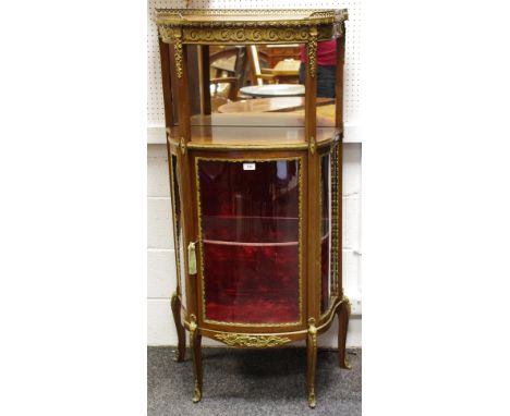 A Louis XVI style gilt metal and mahogany bow fronted display cabinet,  the frieze inlaid with vitruvian scrolls, above an op