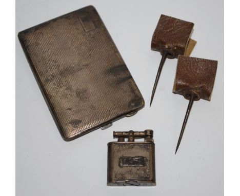 An early 20th century silver cigarette case; a Dunhill lighter; a match striker; spurs. (4)