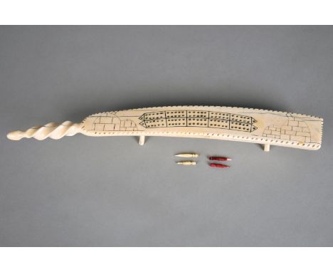 λAn Inuit cribbage board Arctic, early to mid 20th century walrus ivory, with a spiral carved end and incised two images of i