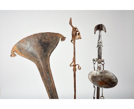 A Dogon staff Mali iron, with a figural terminal and an applied bell, 63.5cm high, mounted, a Dogon iron lamp with an applied