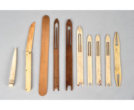 λSix Inuit net needles bone and wood, the longest, 18.3cm, an Inuit net bobbin, an awl and a model folding knife, marine ivor