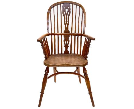 An attractive yew wood Windsor armchair, 20th century, seat impressed 'R E Ley'. The high stick filled back with a central pi