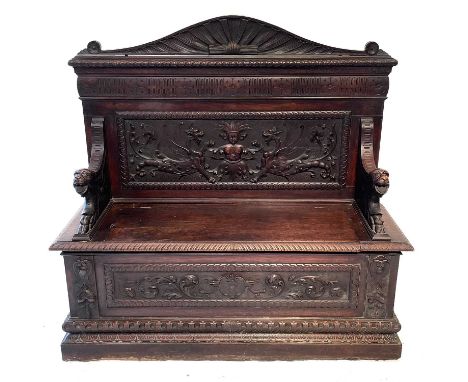 A Victorian carved oak hall bench. Height 131cm, width 135cm, depth 44cm.Large areas of historic woodworm. Back panel is not 