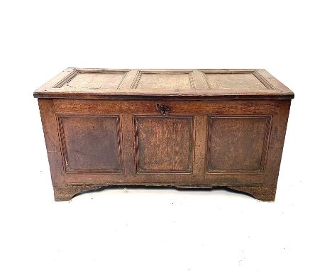 An oak coffer, 17th century. With a triple paneled top and front, raised on later bracket feet, height 60cm, width 117cm, dep