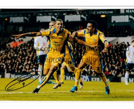 JERMAINE BECKFORD     Autographed 12 x 8 col photo of the Leeds United striker celebrating after scoring his first of two goa