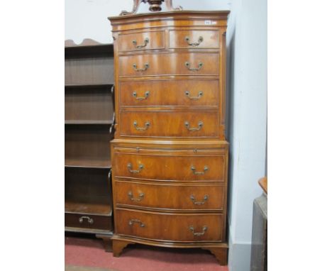 A XX Century Walnut Chest on Chest, with a brushing slide, on bracket feet, 152cm high.