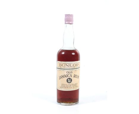A bottle of Dunlop Old Jamaica Rum. Distributed by Dunlop Mackie & Co Bristol, fill level to shoulder, no qty or vol shown, s