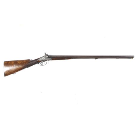 A circa 1860 Manton double barrelled 20 gauge side by side shotgun. With 30.5" Damascus barrels with original loading rod wit