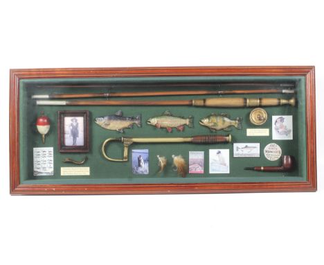 A well presented display board of vintage fishing equipment and ephemera. Including vintage fishing tackle, wooden carvings o