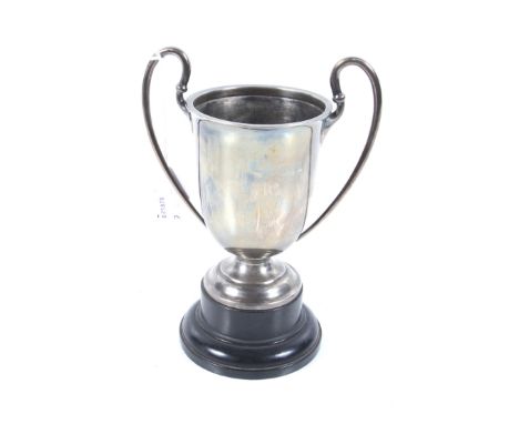 A small silver trophy cup. With two scroll handles, an everted rim and a domed foot, no inscription, mark of Barker Brothers,