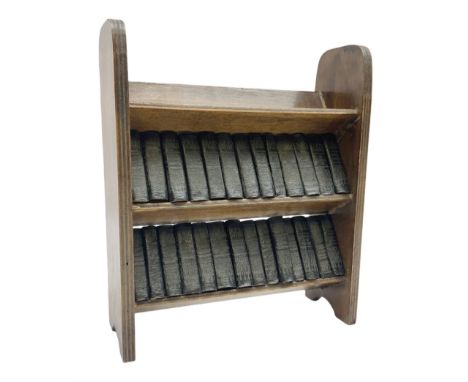 Miniature works of William Shakespeare c.1930, black faux leather covers, housed in a three tier open trough bookcase, pub. A