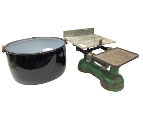 Set on cast iron scales and weights, together with an enamelled pot with handle 