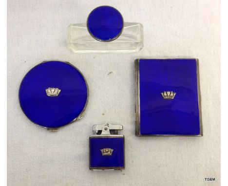 A set of matched items in silver including a cigarette lighter and case, perfume bottle and compact