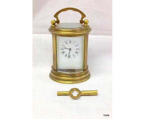 A brass cased miniature carriage clock timepiece