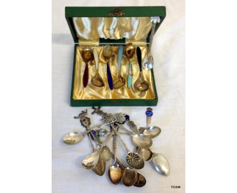 A collection of silver and enamel spoons etc
