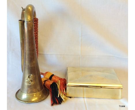 A brass bugle and cigarette presentation box