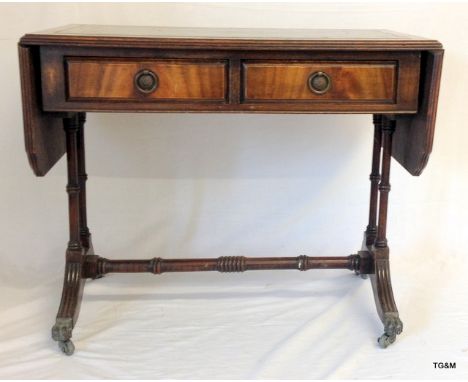 A mahogany leather topped sofa/coffee table with two drawers