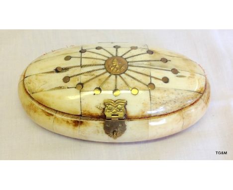 An oval bone trinket box with brass fittings