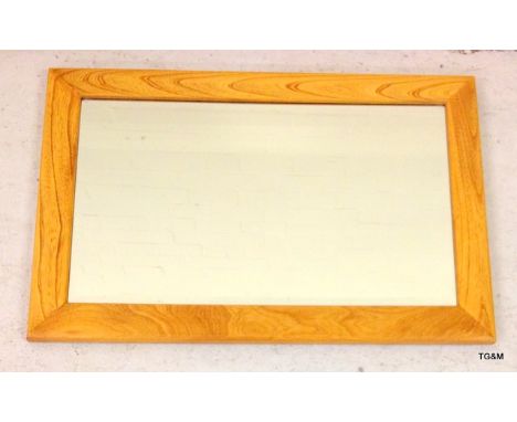 An Ercol wall mirror with bevelled glass 47 x 71