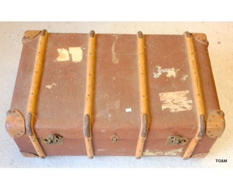 A wooden bound travelling trunk with internal tray