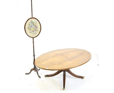 Mahogany oval topped coffee table on quartefoil base and brass caps and castors, H50 W122 D84.5 cm, together with a mahogany 