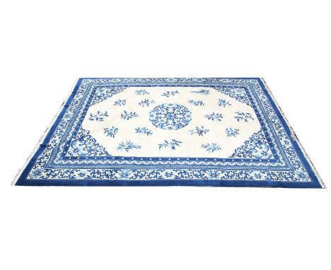 Chinese carpet with central floral medallion and floral motifs on a cream ground within floral and geometric borders, 364 x 2