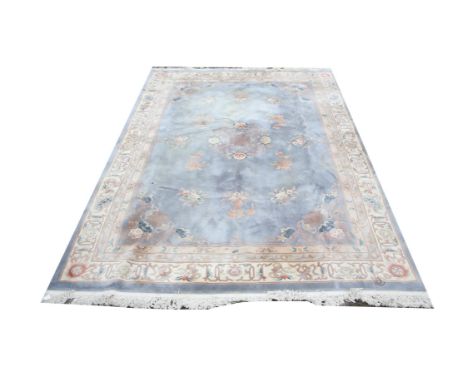 Chinese wool pile carpet, with central floral medallion and floral motifs on a light blue ground within floral borders, appro