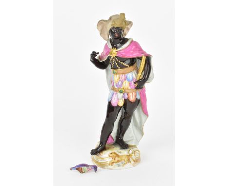 A late 19th century Meissen porcelain figure of Allegory of Africa, modelled by F E Meyer, as a blackamoor richly clothed, ho