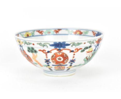 A Chinese wucai porcelain 'immortals' bowl, with doucai decoration of underglazed blue and applied enamels, the inside of the