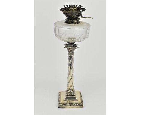 An Edwardian silver oil lamp by the Goldsmiths and Silversmiths company, London 1907, in the Adams style with foliate tapered