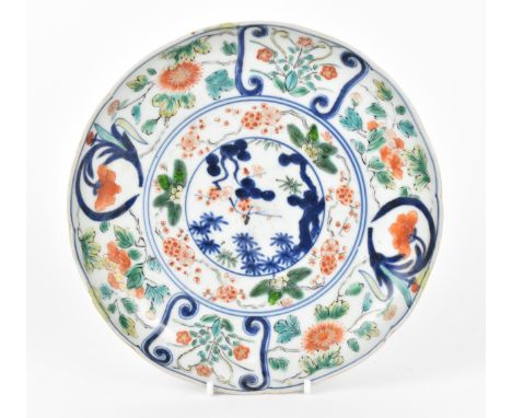 A Chinese Qing dynasty Famille Verte porcelain dish, 18th century, of circular lobbed form with applied enamels and underglaz