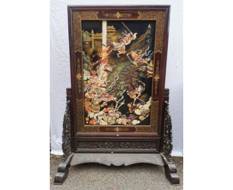 A large Chinese hardstone, lacquer and hardwood screen, with central mythological battle scene, possibly of the Monkey king d