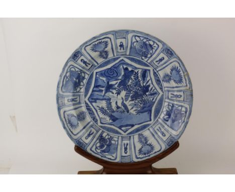 A Chinese Qing dynasty blue and white porcelain kraak charger, probably Kangxi period (1661-1722), decorated to the centre wi