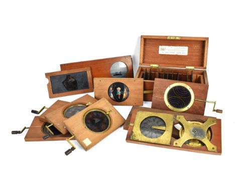 A collection of Victorian magic lantern mahogany framed slides, to include five with winding handle to move image, and one wi