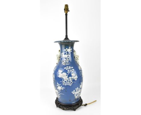 A large Chinese blue and white porcelain vase converted to a lamp, of baluster form, the blue body with raised white prunus b