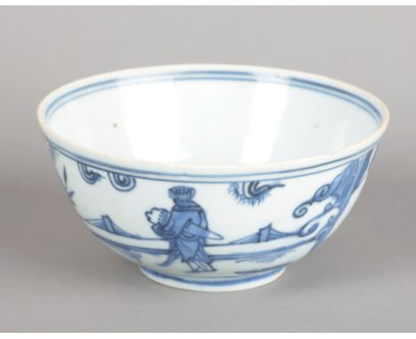 A CHINESE PORCELAIN BLUE AND WHITE BOWL bearing a four character mark to the base, Ming dynasty, decorated with figures in a 
